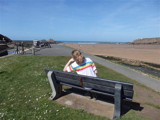 Sit on this bench at Bude beach when staying at Forda Farm Bed and Breakfast, EX22 7BS.